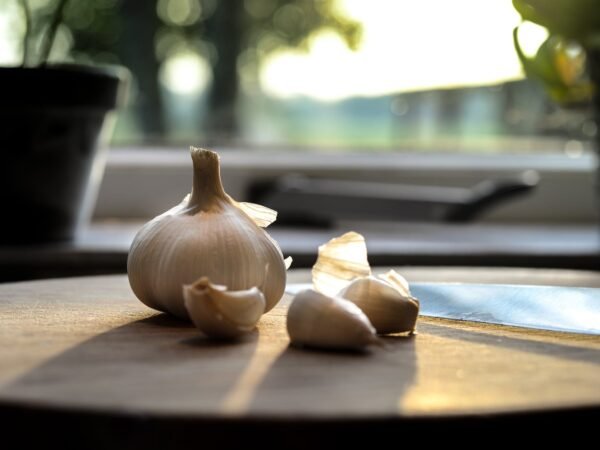 photography of garlic on wooden table