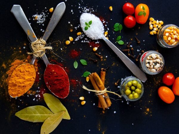 collection of bright spices and fresh vegetables on table